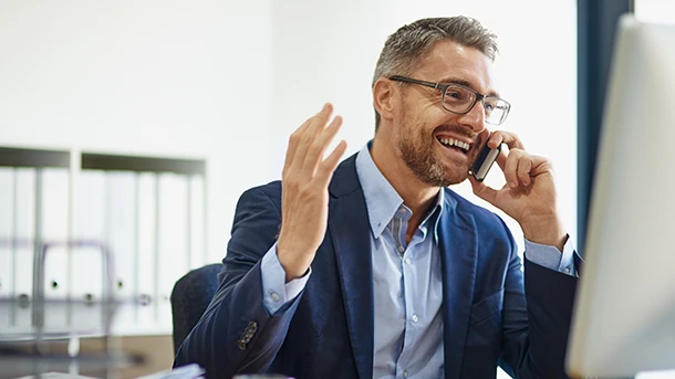 a man in a suit talking on a phone