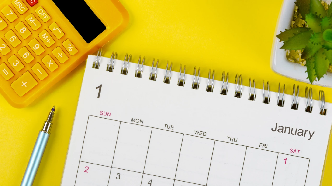 a calendar and calculator on a yellow background