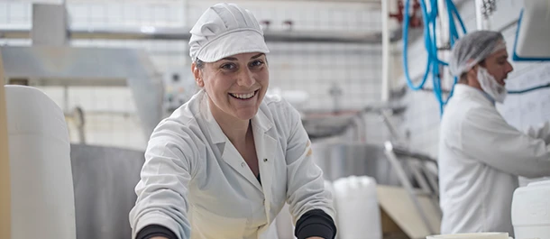 a woman wearing a white hat and white coat