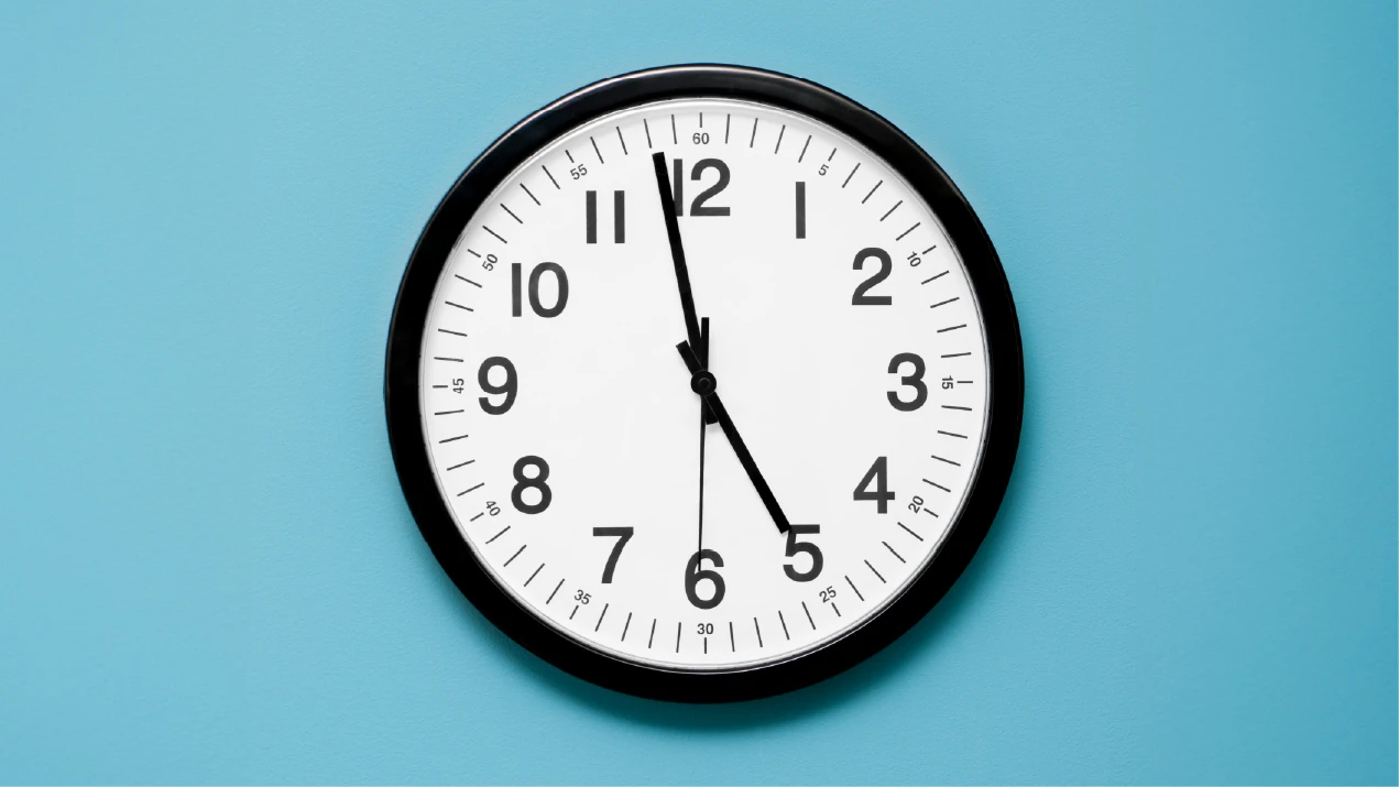 a clock on a blue wall