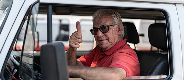 a man in a red shirt giving a thumbs up