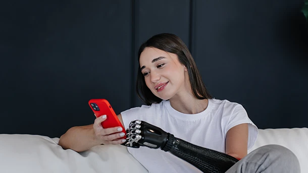 a woman with a prosthetic arm and a red phone
