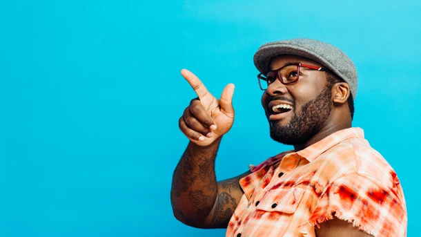 Guy pointing, blue background