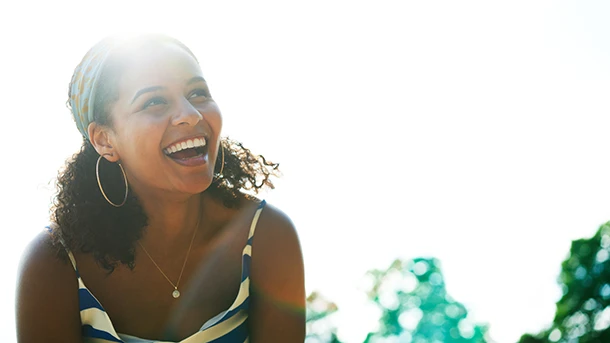 a woman laughing with her mouth open