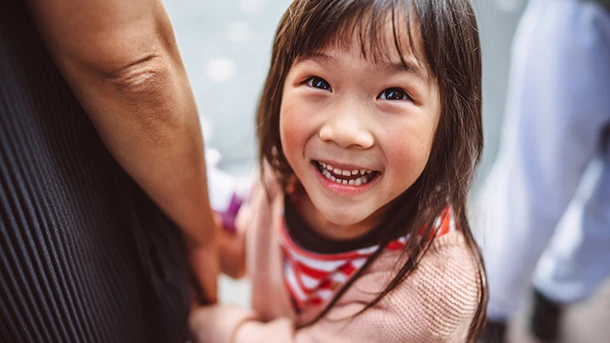a child smiling looking up at something