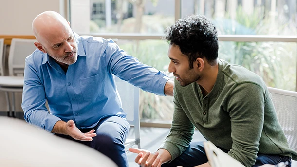 a man talking to another man