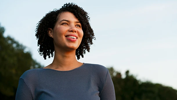 a woman smiling with a blue shirt